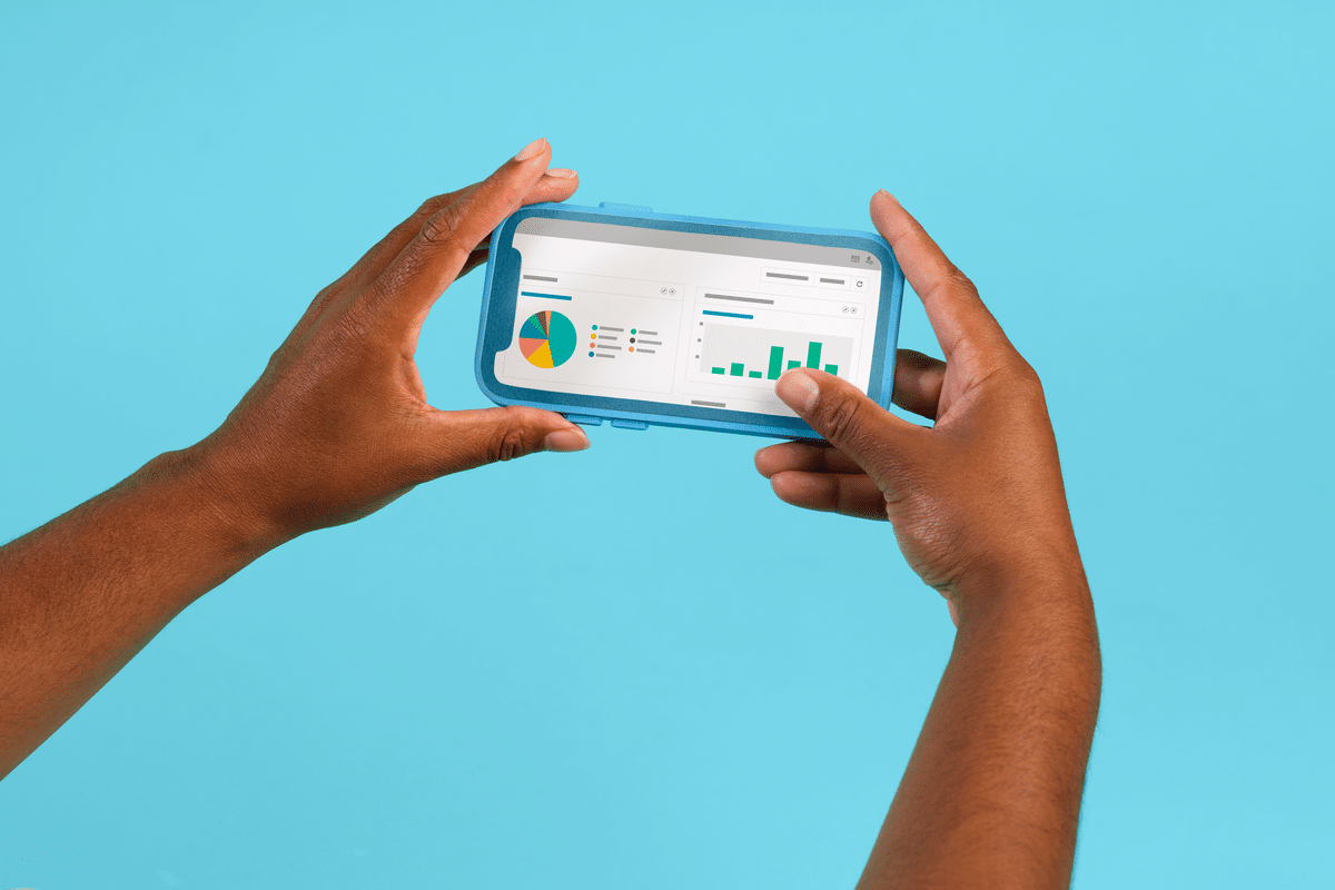 IT Asset Management - Hands holding a smartphone showing a dashboard